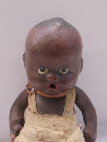 A small black baby doll, 11 cm. - Image 2 of 2