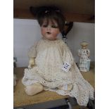 A 19th century porcelain headed doll marked Armand Marseille, Germany, 9900, A-4-M.