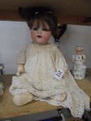 A 19th century porcelain headed doll marked Armand Marseille, Germany, 9900, A-4-M.