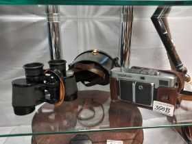 A pair of Zeiss 8 x 30 binoculars and a voigtlander camera.