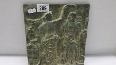 A heavy cast metal plaque depicting a classical scene.