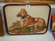 An early 20th century mahogany framed tapestry of a dog.