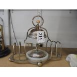 A retro silver plate toast rack incorporating conserve dish.