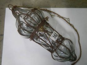 A hanging glass and metal hall light.