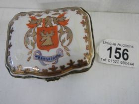 A good early 20th century hand painted porcelain patch/pill box with crest.