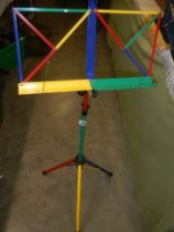 A multi-coloured adjustable music stand.