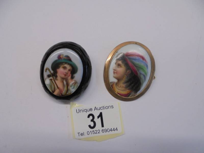A hand painted brooch in a 9ct gold mount and another brooch.