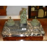 A Victorian bronze inkwell featuring a figure on a slate base. COLLECT ONLY.