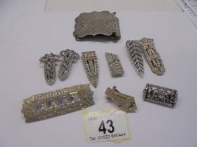 A quantity of paste clips and brooches, art deco in white metal, one stamped 'Kutiklip, ten in total