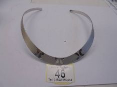 A heavy quality silver collar with textured front.