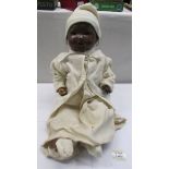 A vintage British made black baby doll (hands a/f).