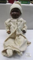 A vintage British made black baby doll (hands a/f).