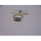 An 18ct yellow gold three stone diamond ring, size L, 2 grams.