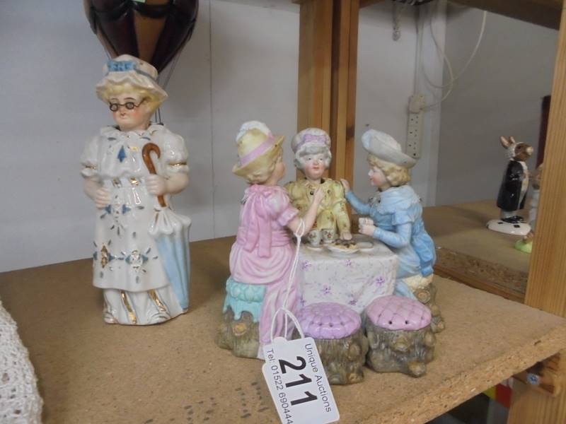 A 19th century nodding head teaparty group and a 19th century nodding Granny figure.