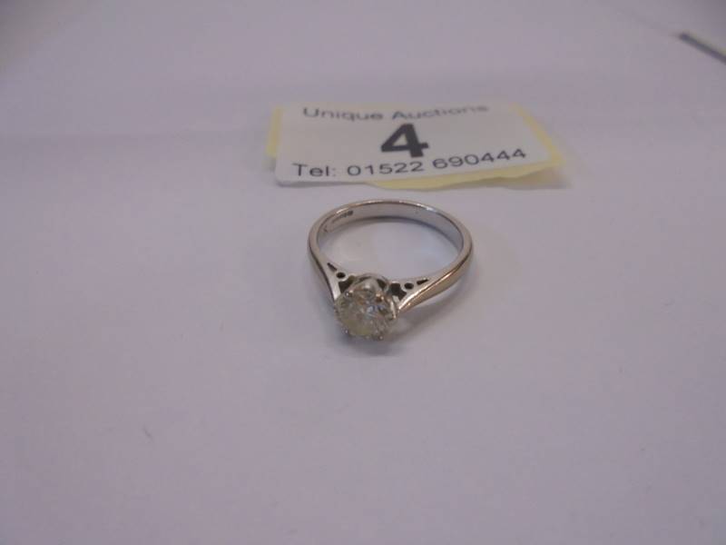 An 18ct white and yellow gold ring set single stone diamond, size I, 2.7 grams.