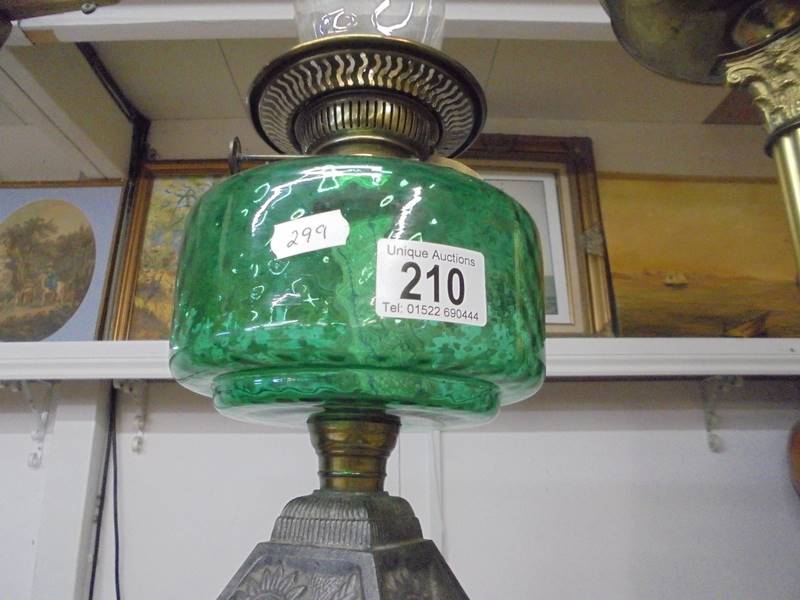 An early 20th century oil lamp on cast iron base with green glass font and chimney. COLLECT ONLY. - Image 3 of 3