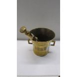 A brass pestle and mortar stamped 1825.