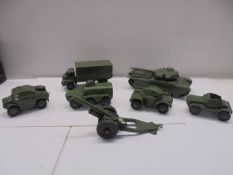 Seven Dinky military vehicles including tanks, cannon etc.,