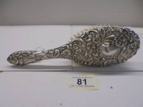 A silver backed hair brush (some minor dents).