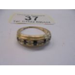 A sapphire and white stone set band ring in 9ct gold shank, size L, 2 grams.