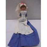A vintage cloth nurse doll.
