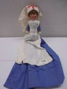 A vintage cloth nurse doll.