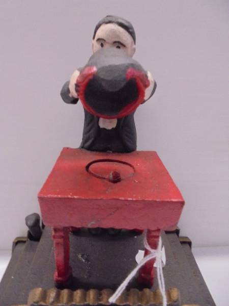 A cast iron magician money bank. - Image 2 of 3