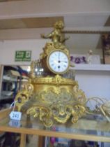 A 19th century gilded mantel clock surmounted figure, in working order.