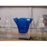 A blue glass oil lamp shade and two oil lamp chimneys.