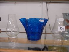 A blue glass oil lamp shade and two oil lamp chimneys.