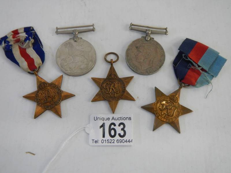 Five medals, The France & Germany Star, 2 x 1939-45 stars and two other medals.