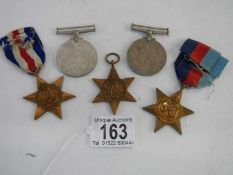 Five medals, The France & Germany Star, 2 x 1939-45 stars and two other medals.