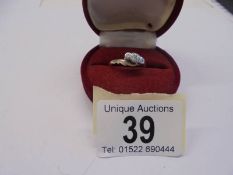 A circa 1940's diamond three stone ring in a twist design, stamped 18ct/Platinum, size O, 2.8 grams