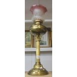 A brass Corinthian column oil lamp with later etched glass shade. COLLECT ONLY.