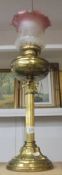 A brass Corinthian column oil lamp with later etched glass shade. COLLECT ONLY.