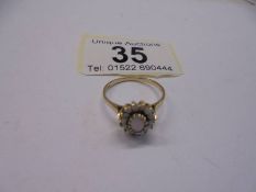 An opal 9ct gold cluster ring, hm for London 1989, good colour dispersion, size O half, 2.1 grams.