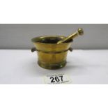 A small brass pestle and mortar.