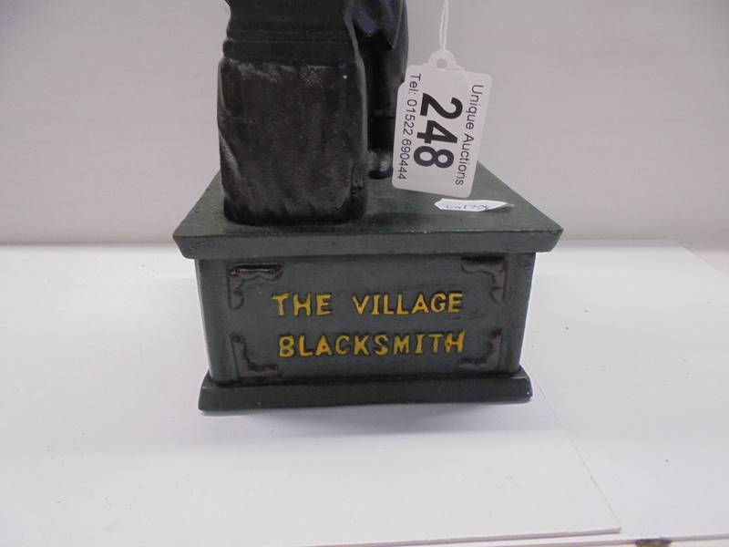 A cast iron The Village Blacksmith money bank. - Image 3 of 3