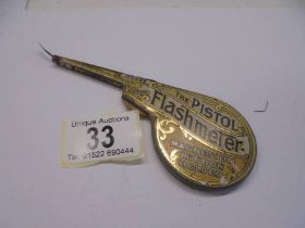 A vintage 'The Pistol Flashmeter' magnesium ribbon holder tin for photographers.