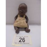 A small black baby doll, 11 cm.