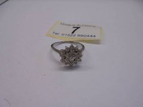 A three quarter carat white gold floral diamond ring, size N, 2.75 grams.