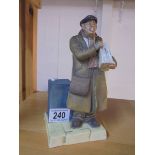 A porcelain figure of a Newspaper seller.