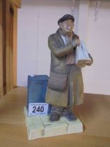 A porcelain figure of a Newspaper seller.