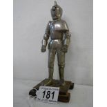 A mid 20th century table lighter in the form of a standing knight.