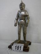 A mid 20th century table lighter in the form of a standing knight.