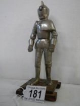 A mid 20th century table lighter in the form of a standing knight.
