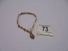 A 9ct gold bracelet with heart padlock. 2.53 grams.
