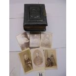 A small Victorian photo album (spine needs repair) and loose photographs.