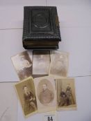 A small Victorian photo album (spine needs repair) and loose photographs.