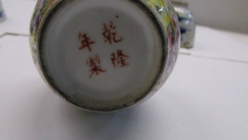 A pair of 19th century Chinese tea bowls (one with early stapled repair) & a miniature Chinese vase. - Image 8 of 8